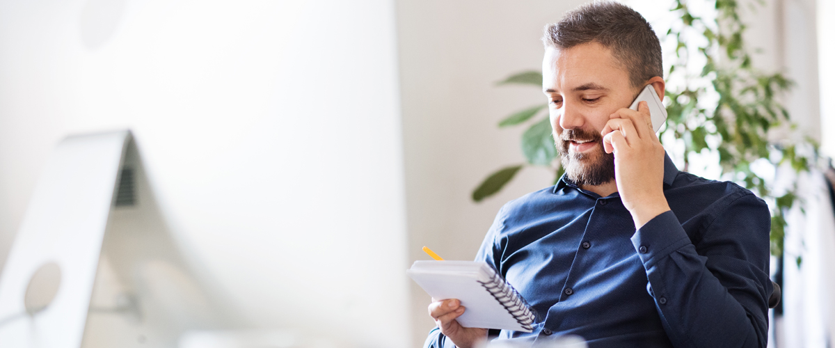 a man on a phone calling his AAT tutor